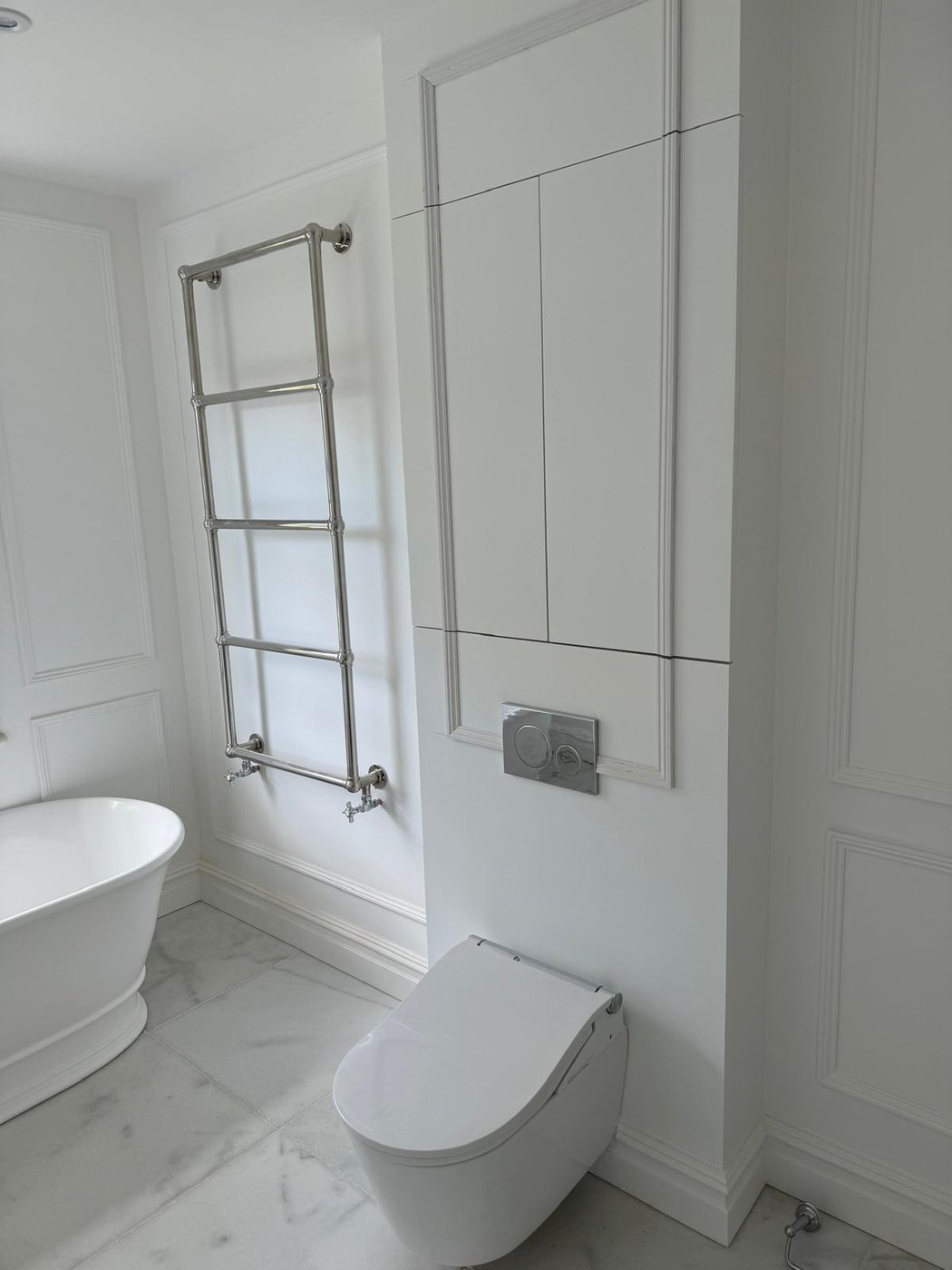 Finished bathroom with a fitted bath, shower screen and vanity unit