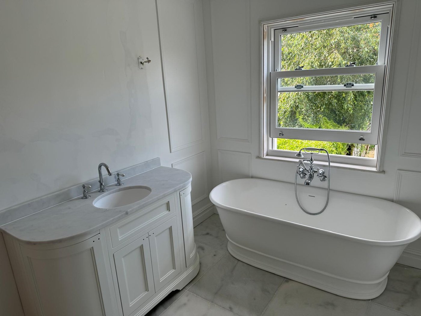 Finished bathroom with a freestanding bath and fitted shower area