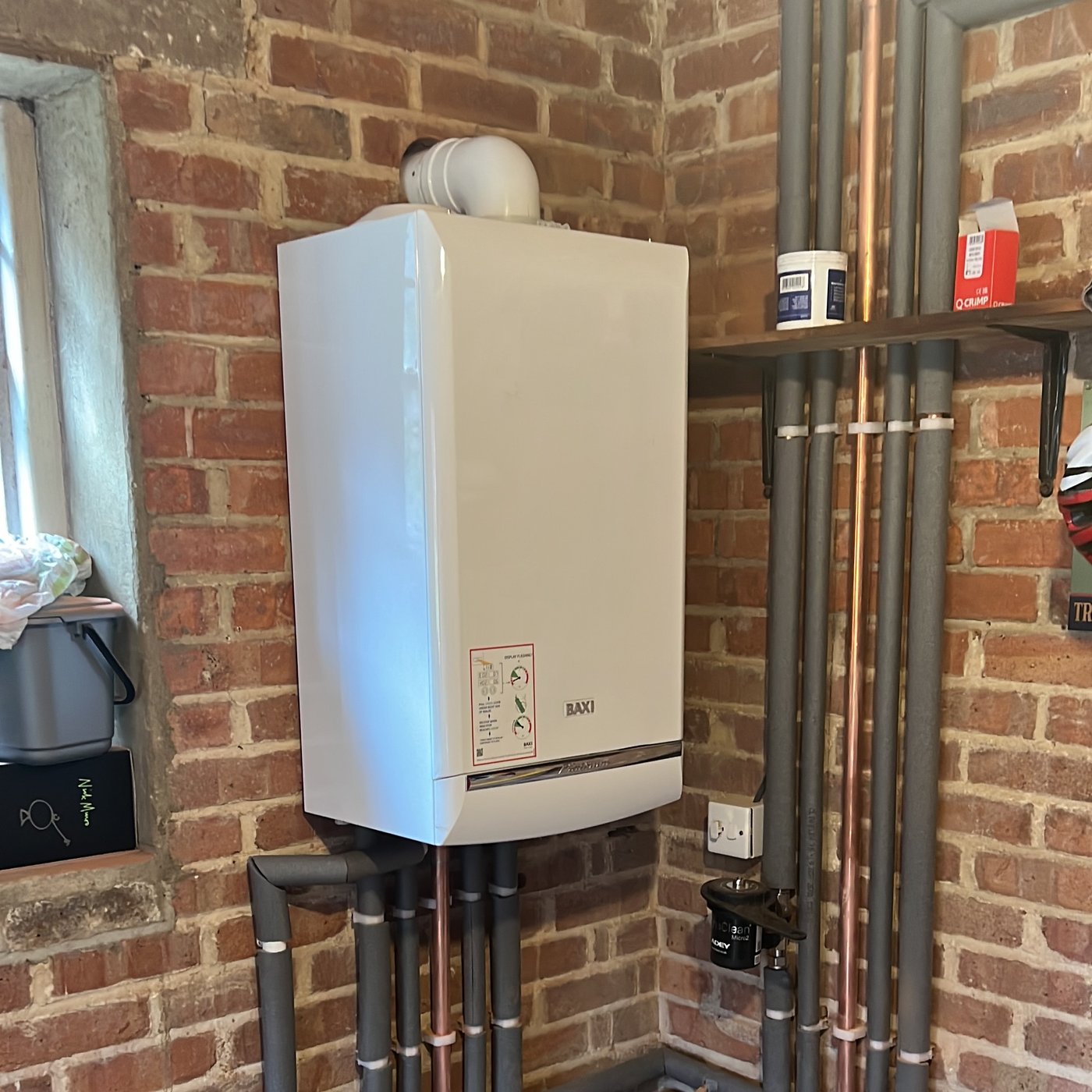 Modern wall-mounted boiler with neatly arranged pipework
